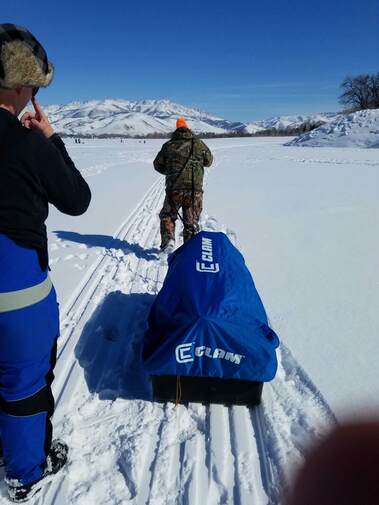 Somebody hauling a 200 pound sled across a frozen lake